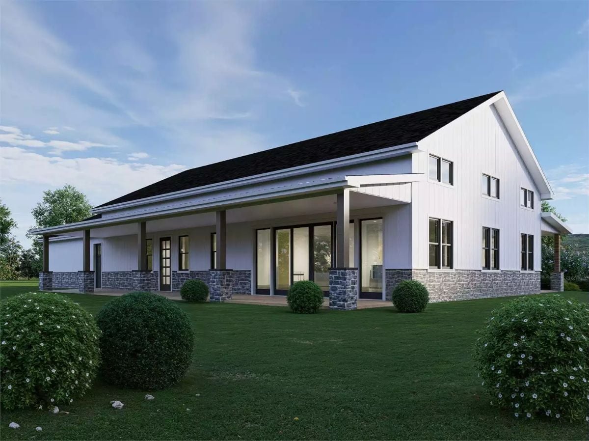 Wraparound Covered Porch Anchored by Stone Columns and Wide Sliding Glass Doors