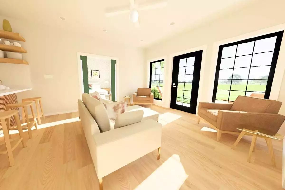 Black-Frame Doors Pull the Yard Into a Sun-Drenched Living Room