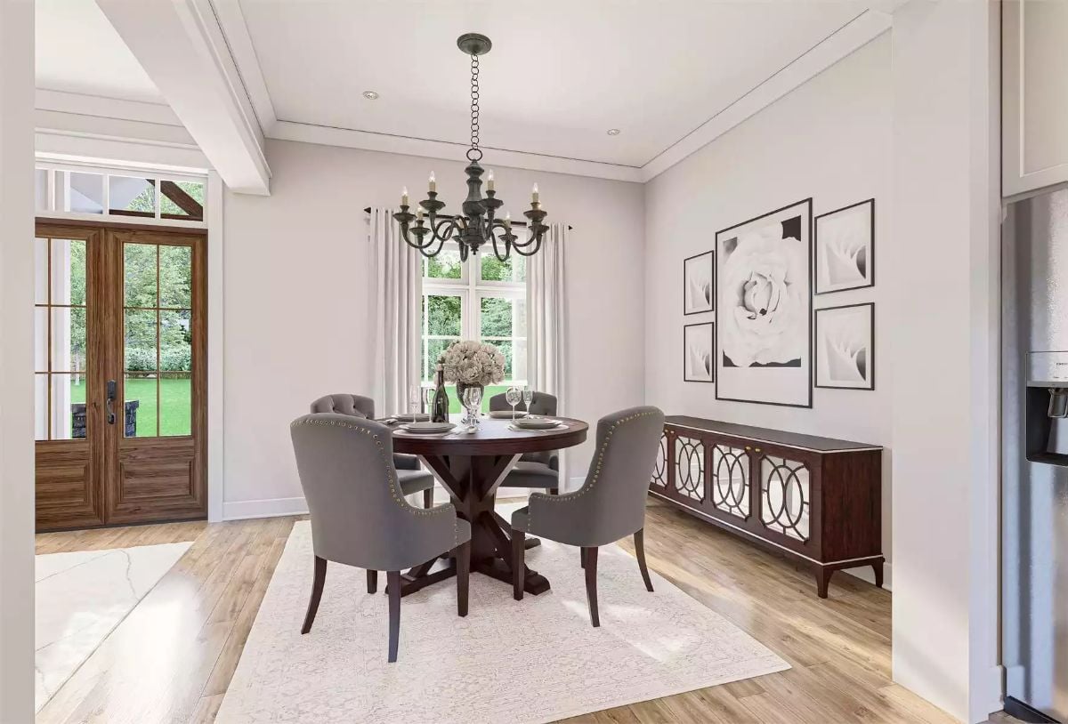 Gray Tufted Chairs Around a Dark Pedestal Table That Pulls the Whole Room Together