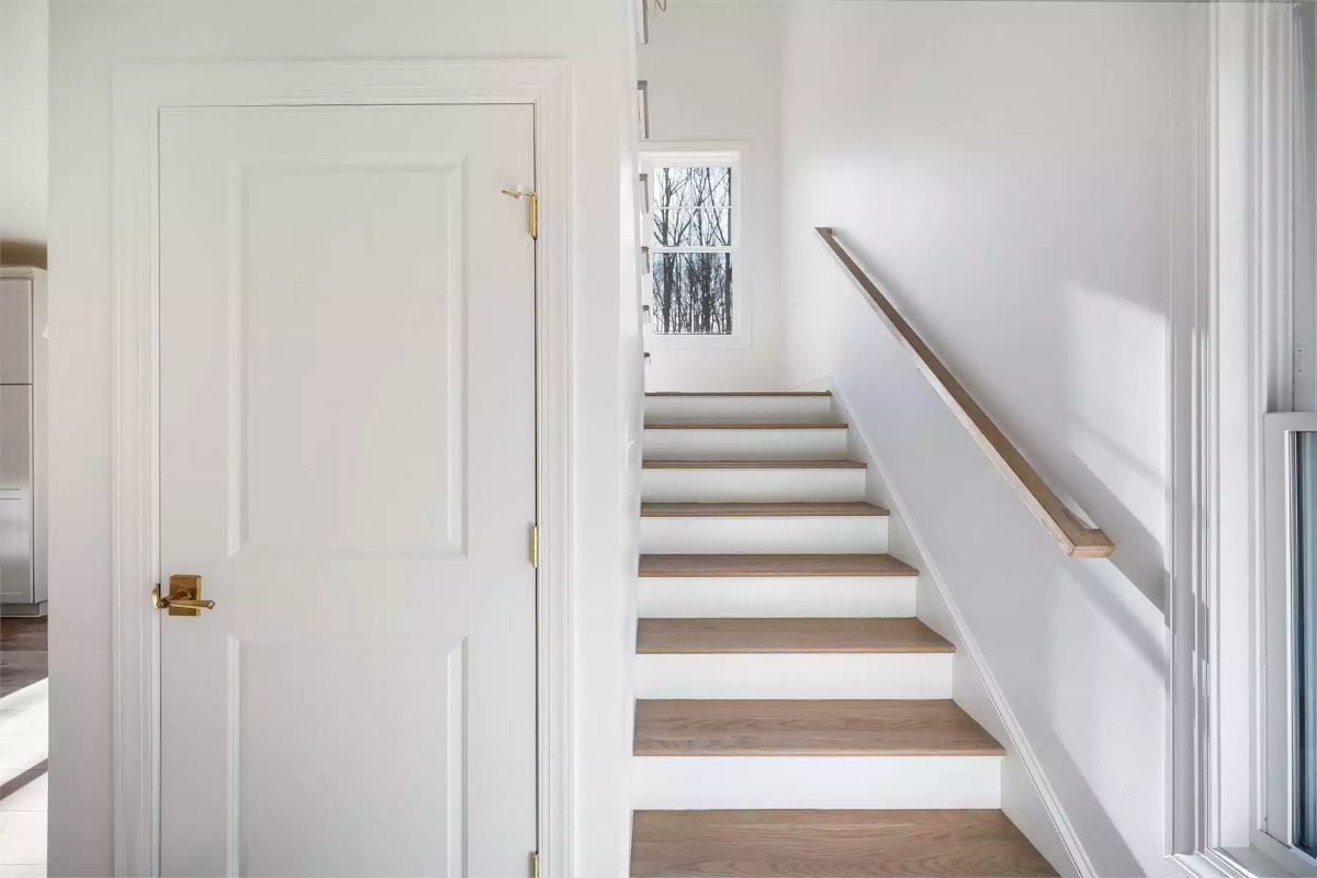 Brass Hardware and Bare Wood Treads Make This Staircase Worth the Climb