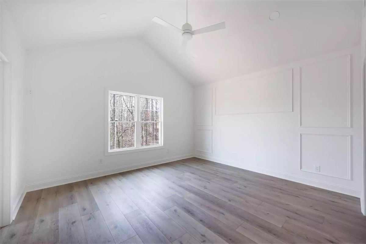 Vaulted Ceiling and Board-Molding Wall Give This Bedroom Two Reasons to Linger