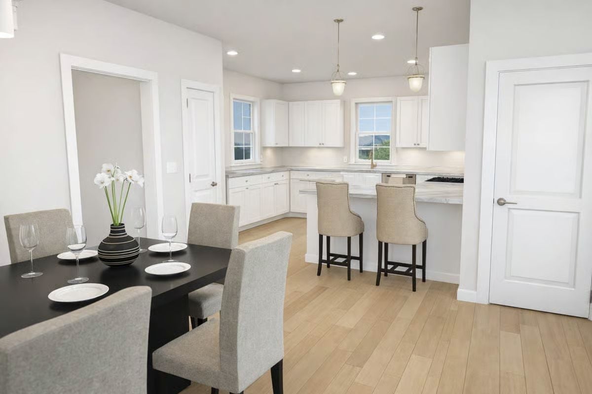 Dark Dining Table Against White Cabinetry Makes the Contrast Do the Work