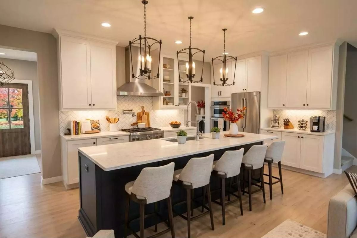 Dark Island Base Against White Cabinetry Earns Its Contrast Here
