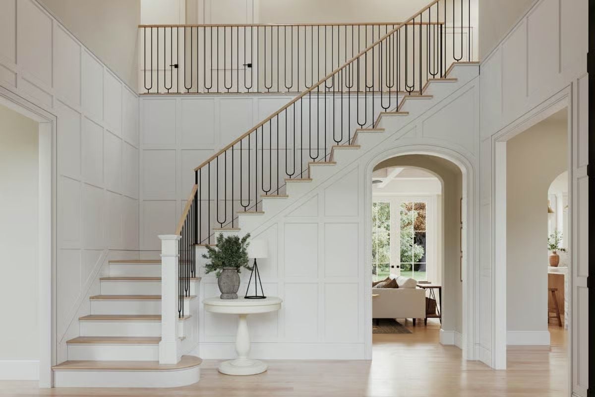 Grand Foyer With Iron Baluster Staircase and Board-and-Batten Walls