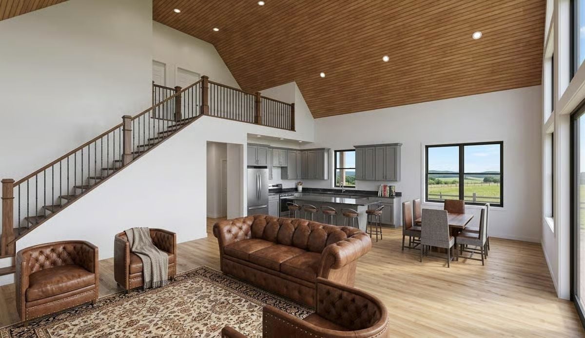 Vaulted Ceilings and Chesterfield Leather Anchor This Barndominium's Main Living Space