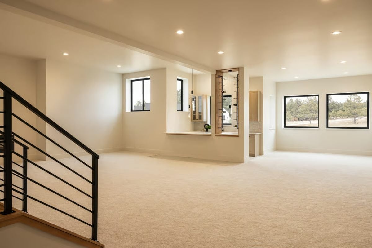 Carpet, Recessed Lighting, and a Built-In Wine Wall Keep This Lower Level Flexible