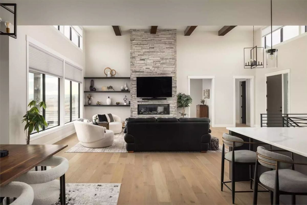 Stacked Stone to the Ceiling and a Black Sofa That Doesn't Apologize