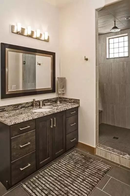Dark Vanity Cabinets and a Doorless Shower That Actually Works