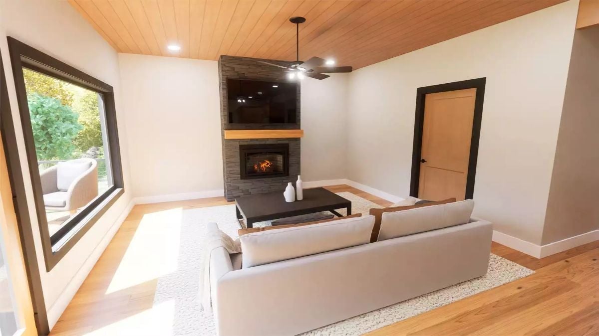 Stone Fireplace Wall and Wood Ceiling Pull This Living Room Together