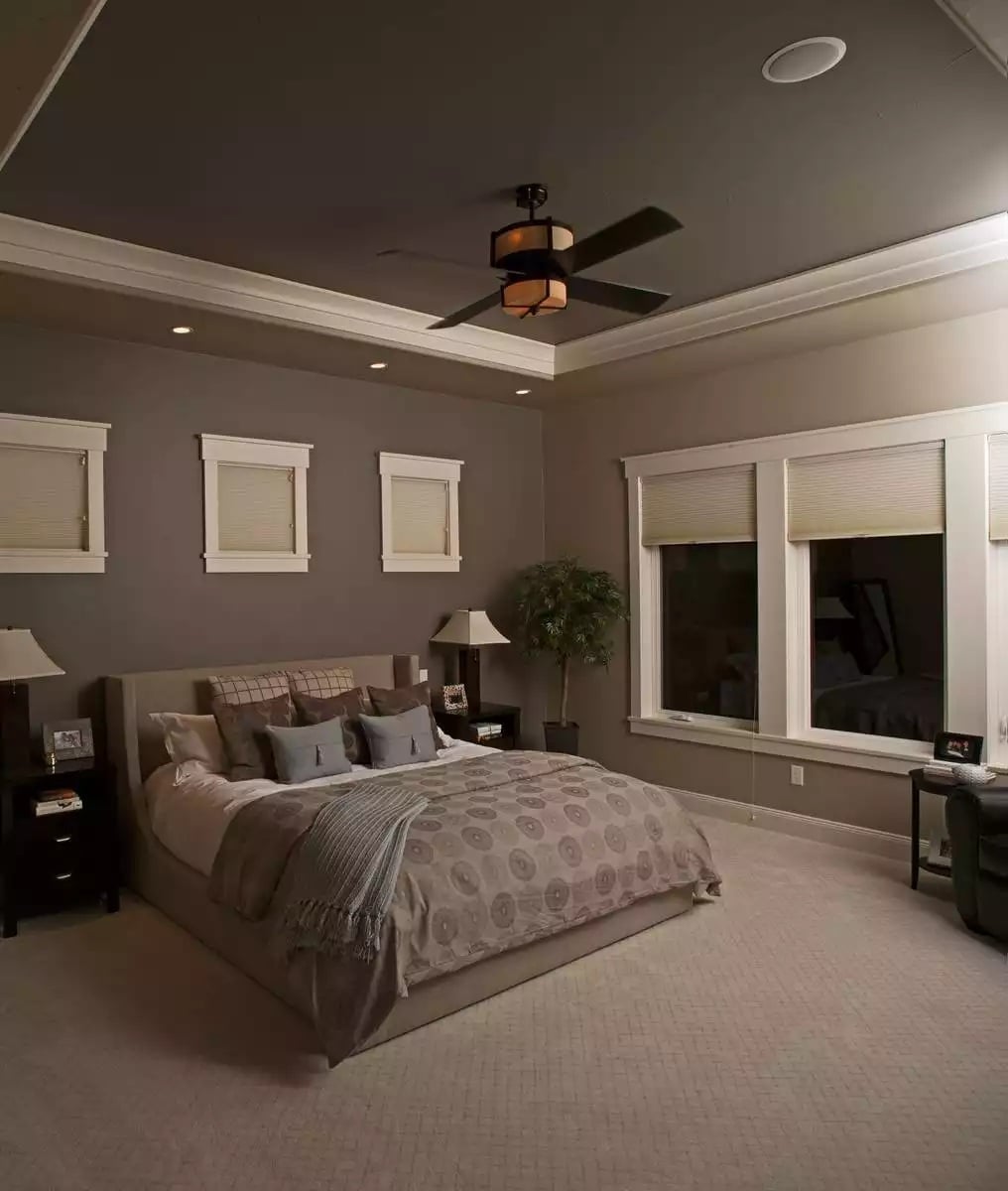 Tray Ceiling and Warm Recessed Lighting Make This Primary Bedroom Feel Settled