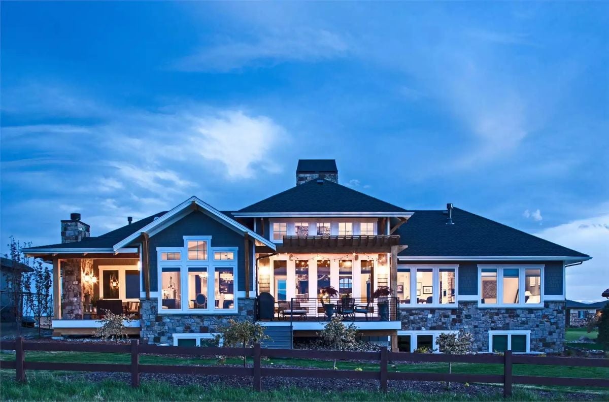 Warm Light Spills from Every Window on This Craftsman's Back Elevation