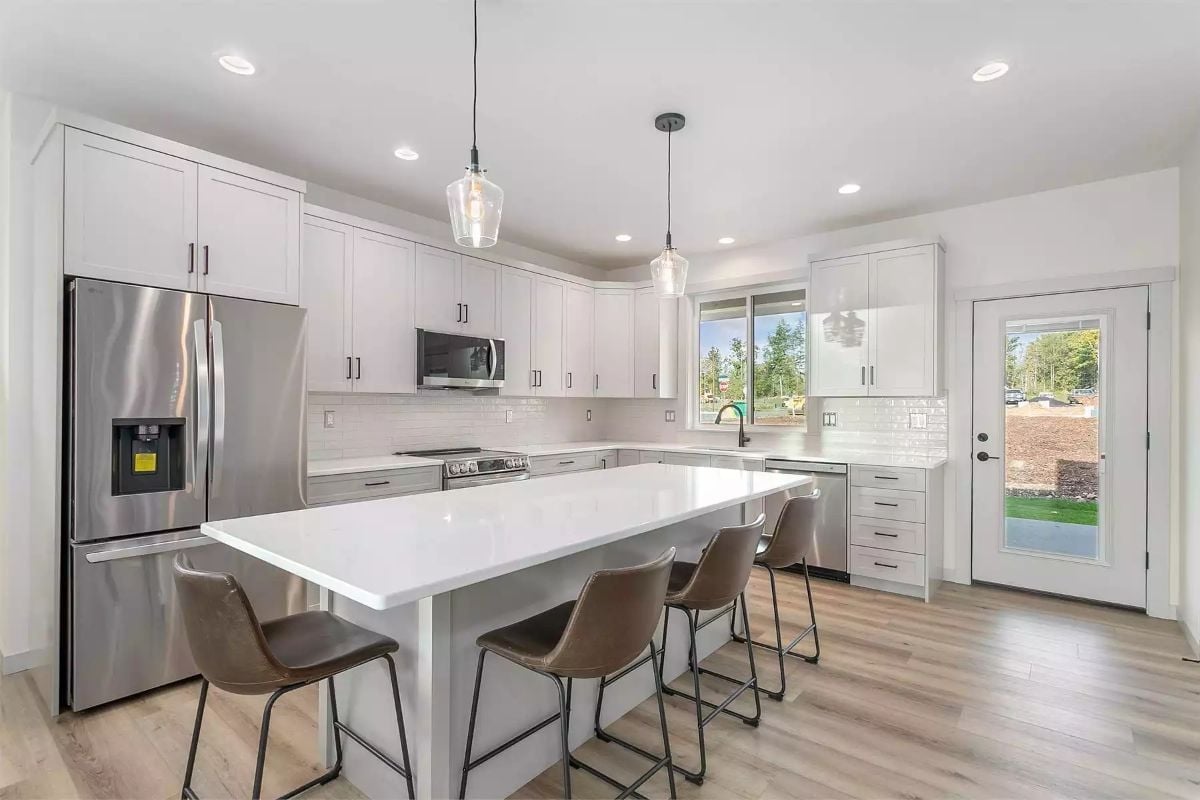 Pendants, Quartz, and Brown Leather Make This Kitchen Feel Finished