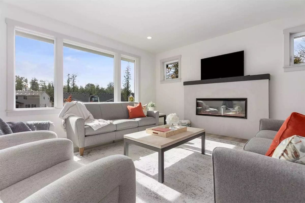 Sunlit Gray and Rust Living Room Built Around a Linear Fireplace