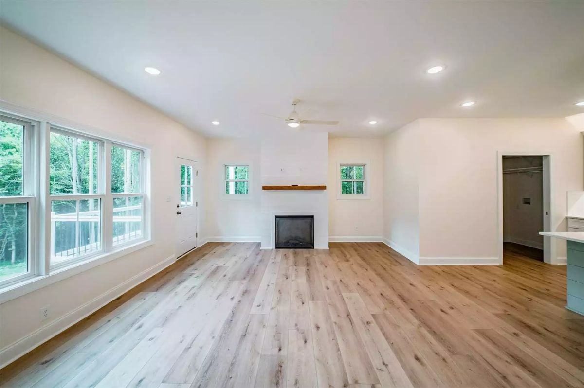 Recessed Lighting, Raw Wood Floors, and a Fireplace That Actually Has Room to Breathe