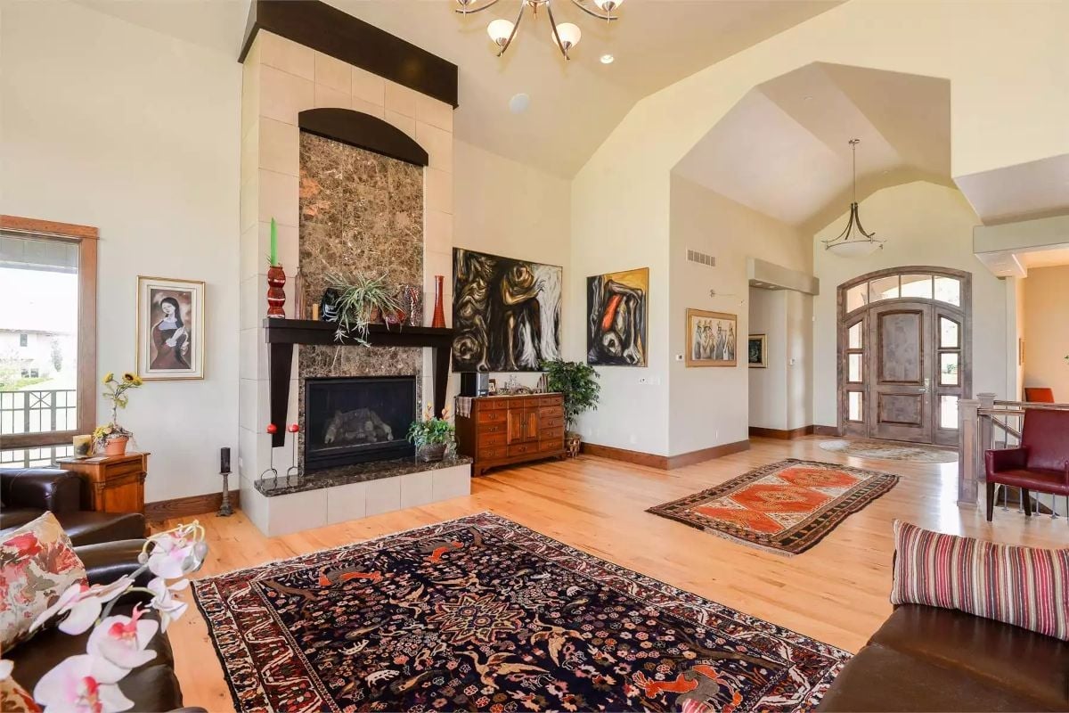 Tall Fireplace Surround and Persian Rugs Doing the Heavy Lifting Here