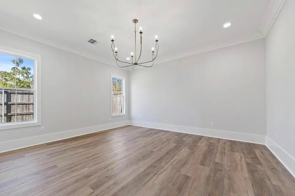 Crown Molding and a Candle-Style Chandelier Make Empty Feel Intentional