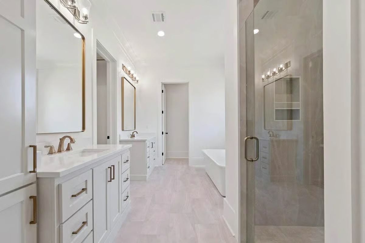 Double Vanities, a Soaking Tub, and a Frameless Shower All in One Room
