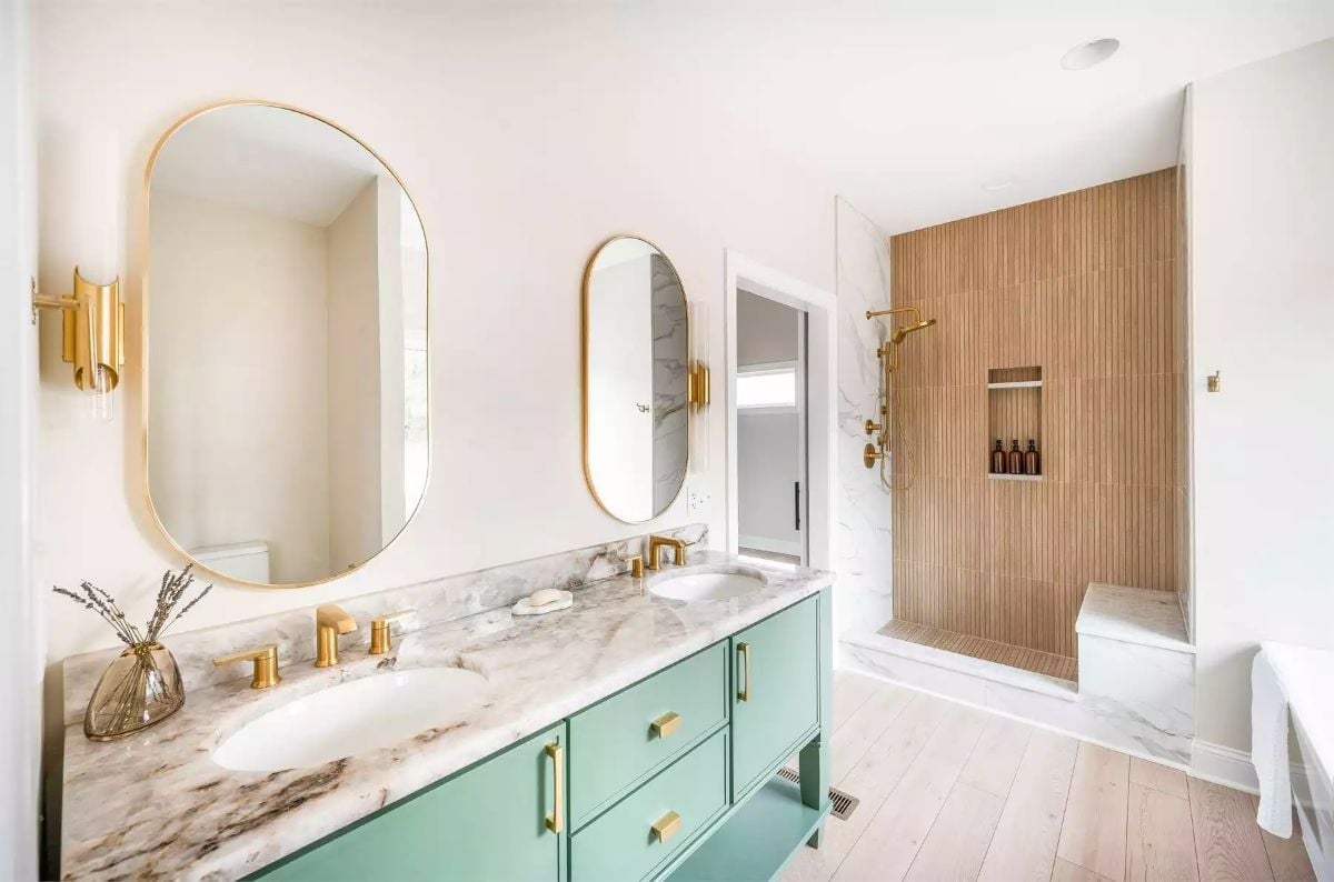 Brass Fixtures, Teal Vanity, and a Shower Wall That Earns Its Keep