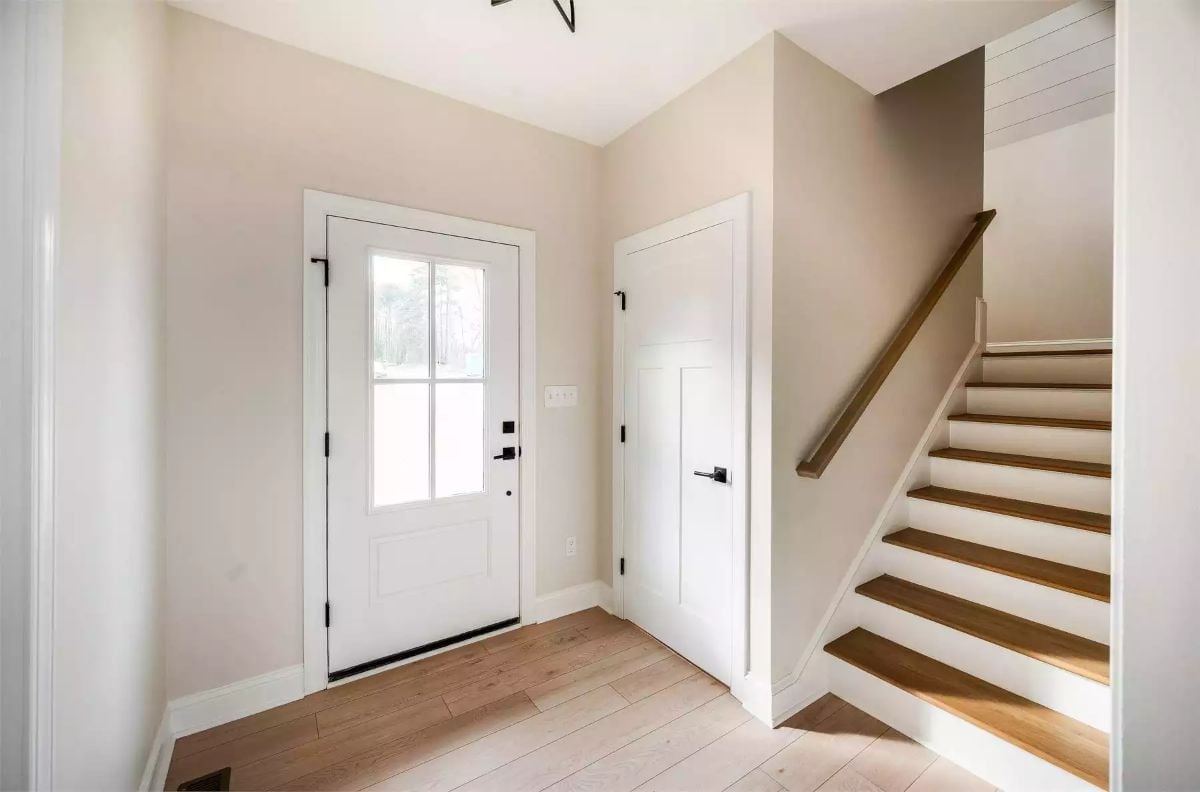 Matte Black Handles, White Paint, and Stairs That Don't Waste an Inch