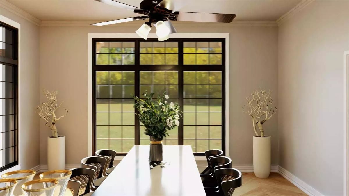 White Dining Table, Black Chairs, and a Wall of Glass That Does the Heavy Lifting