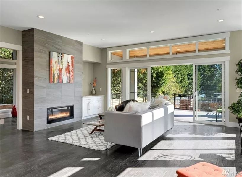 Linear Fireplace, Dark Hardwood, and Sliding Glass That Opens the Room Right Up