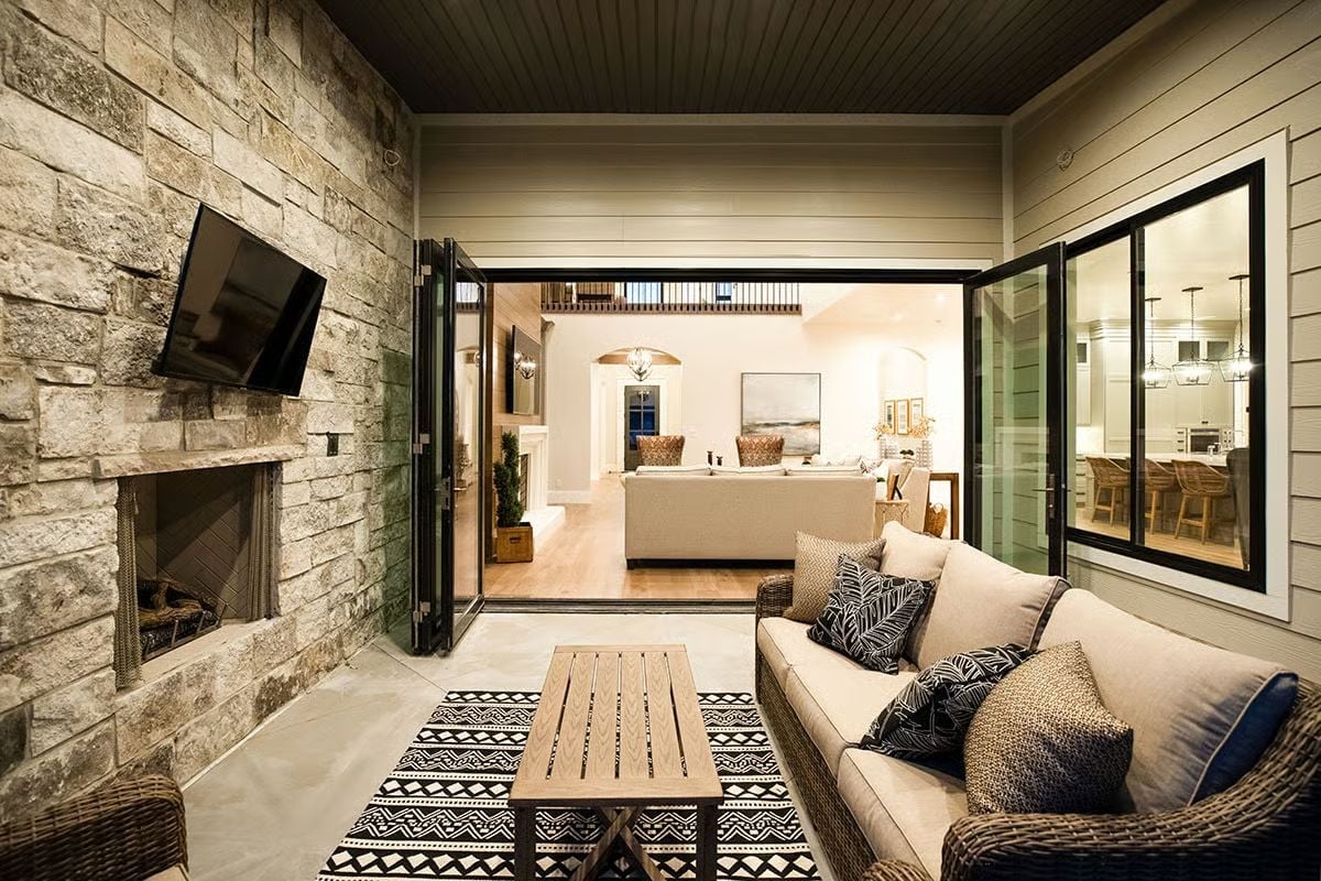 Stone Fireplace, Folding Doors, and an Outdoor Room That Earns Year-Round Use