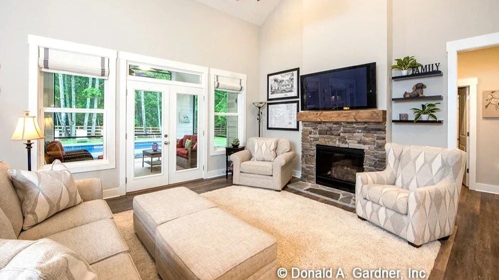 Stone Fireplace and Patterned Armchairs Give the Living Room Real Character