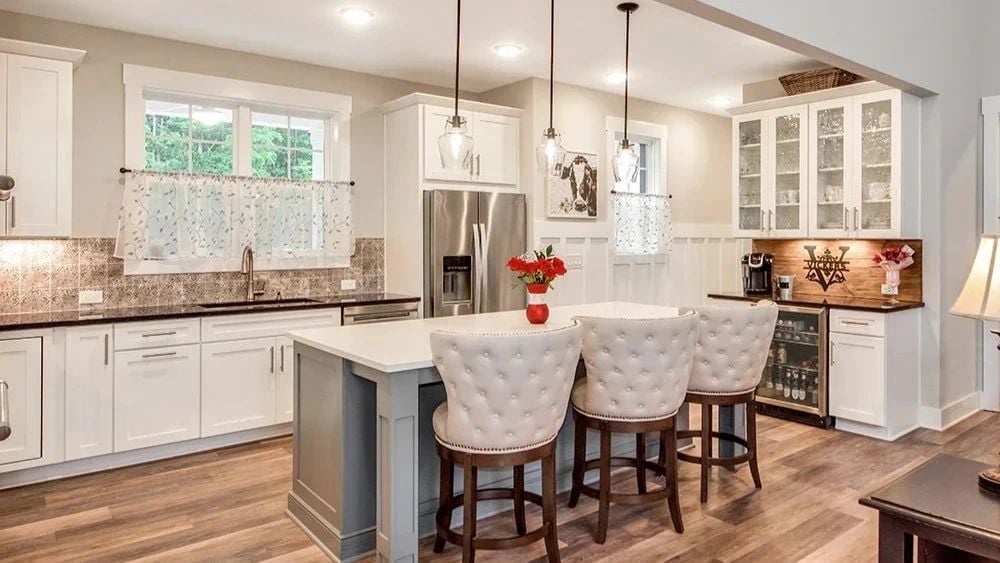 Tufted Barstools and a Gray Island Anchor the Kitchen Without Competing