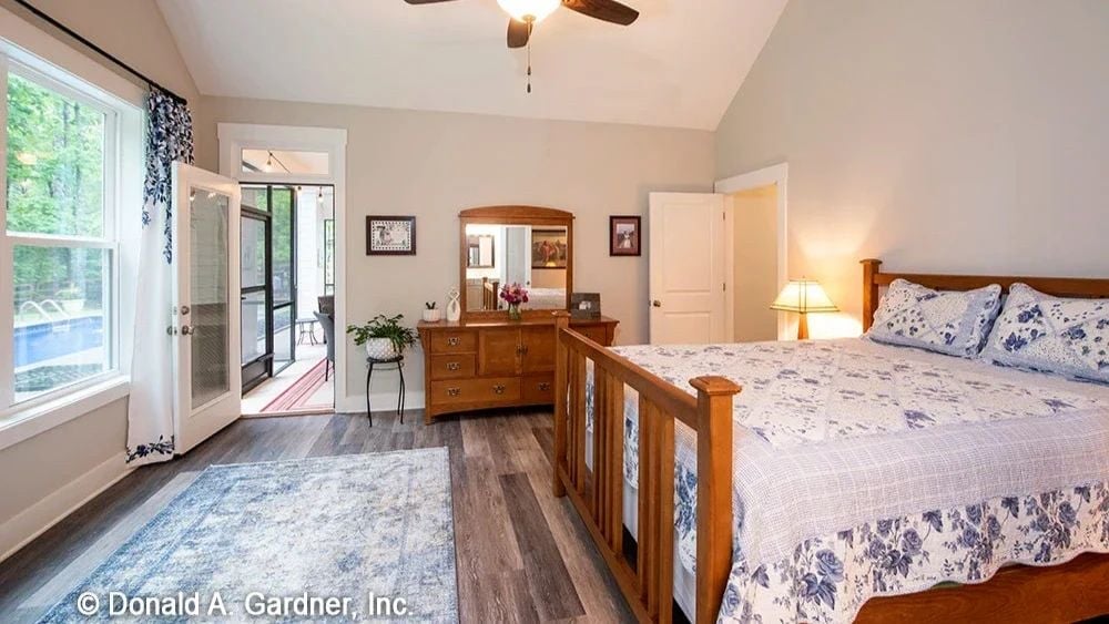 Vaulted Ceiling and Wood Bed Frame Keep the Master Bedroom Grounded