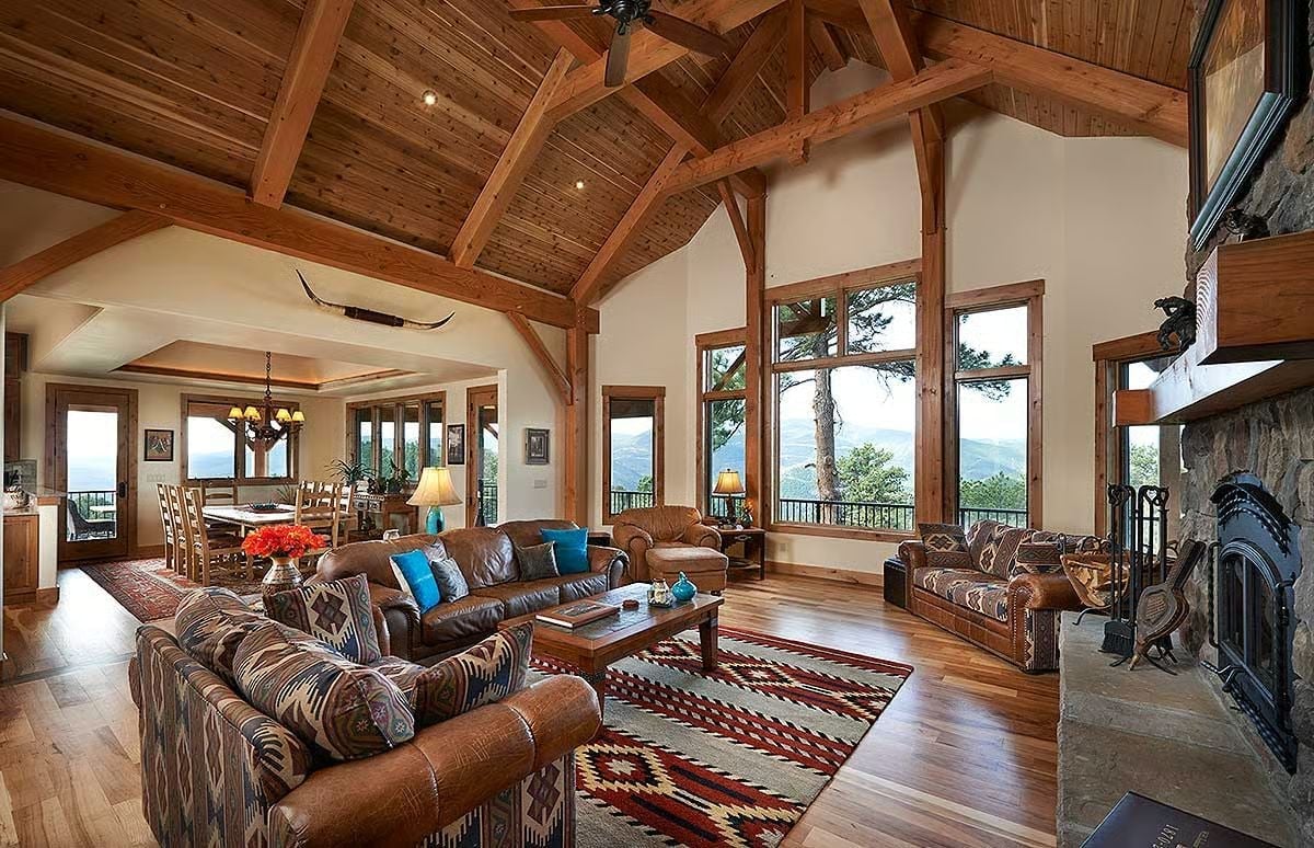 Exposed Timber Trusses and a Stone Fireplace Set the Tone for Every Room Beyond