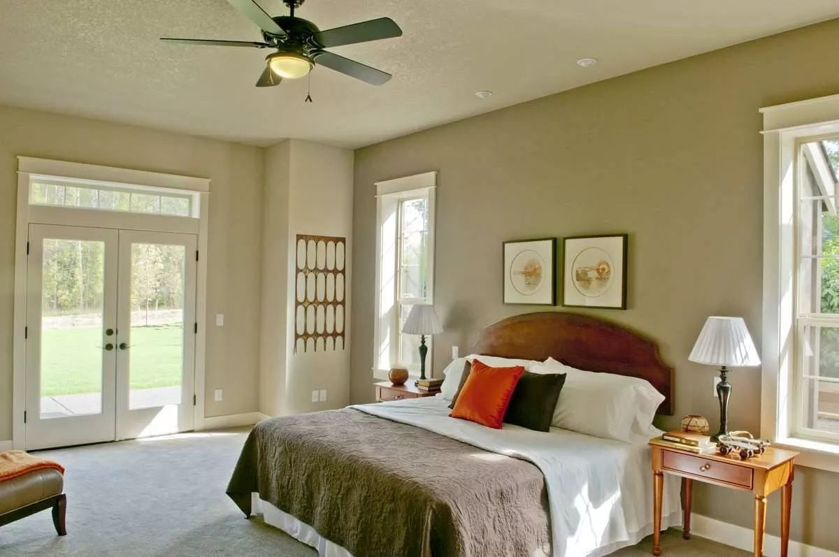 Warm Light, Wood Headboard, and French Doors That Open Straight to the Lawn