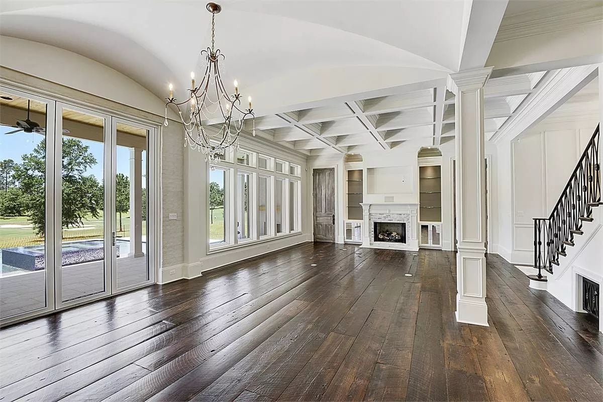 Coffered Ceiling, Crystal Chandelier, and Wide-Plank Floors That Mean Business