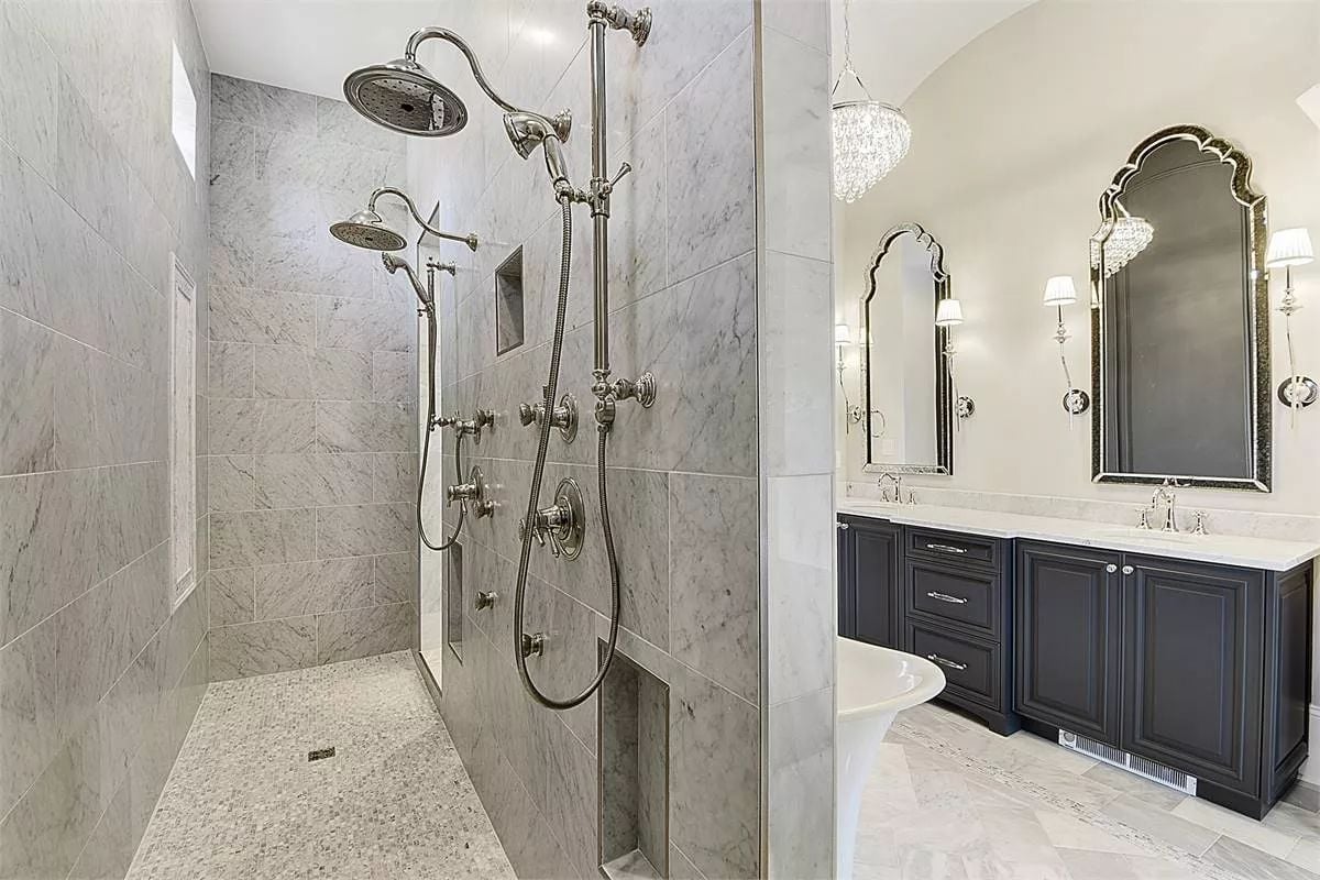 Polished Nickel Fixtures and Marble Tile Built for Two People Who Won't Share a Showerhead