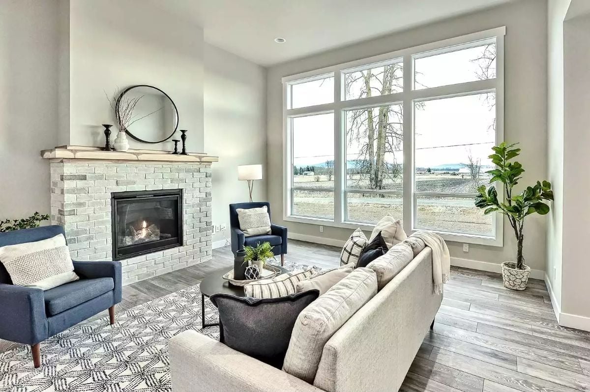 Whitewashed Brick and Navy Chairs Pull This Living Room in Two Good Directions