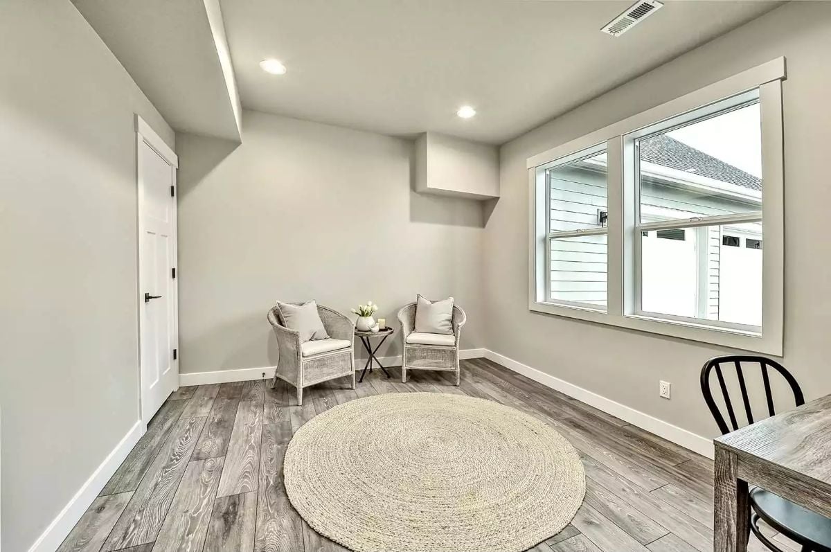 Wicker Chairs and Gray Wood Floors Make This Bonus Room Worth the Stairs