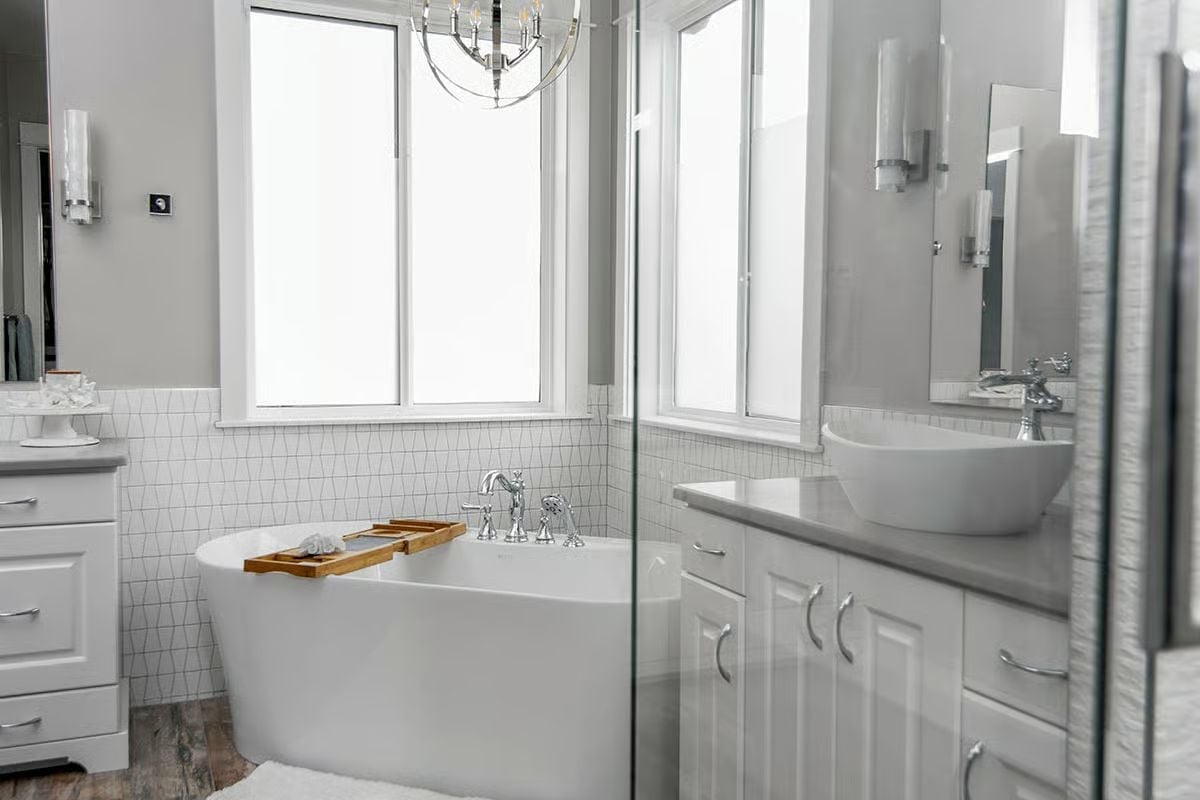 Freestanding Soaker Tub Centered Under Three Windows Is the Whole Point of This Room