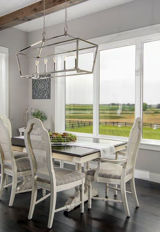 Polished Nickel Lantern Over Cane-Back Chairs Frames the Farm View
