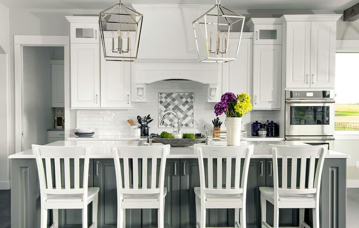 Polished Nickel Lanterns Hang Over a Gray Island Built for Real Cooking