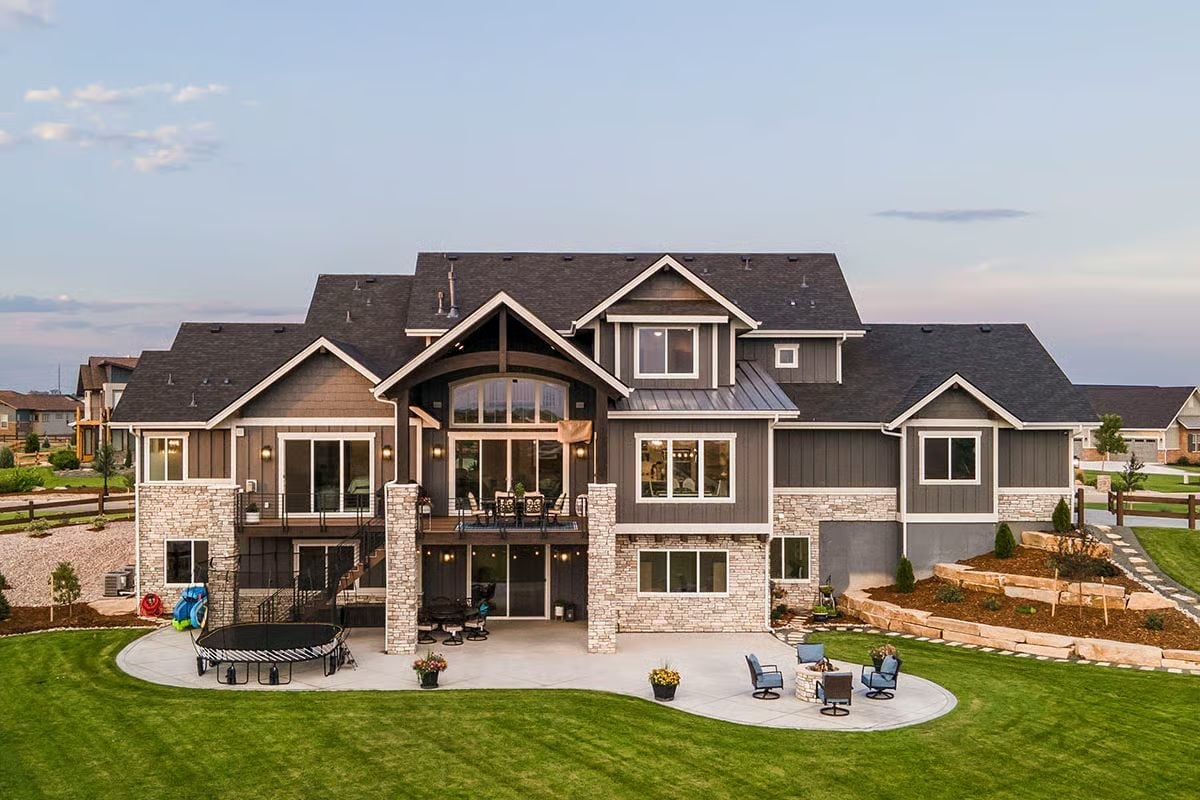 Stone Base and Dark Siding Make the Backyard Elevation Do Real Work