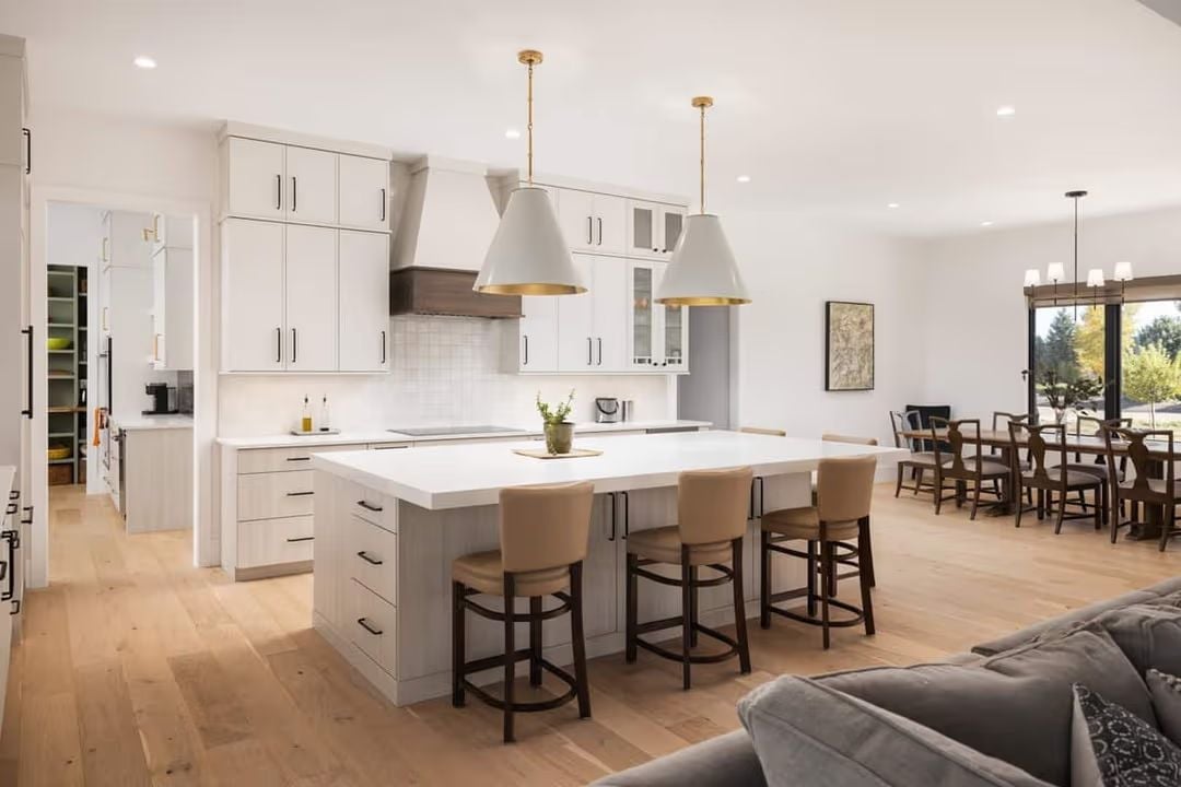 Gold-Lined Pendants and a Waterfall Island Worth Centering a Kitchen Around