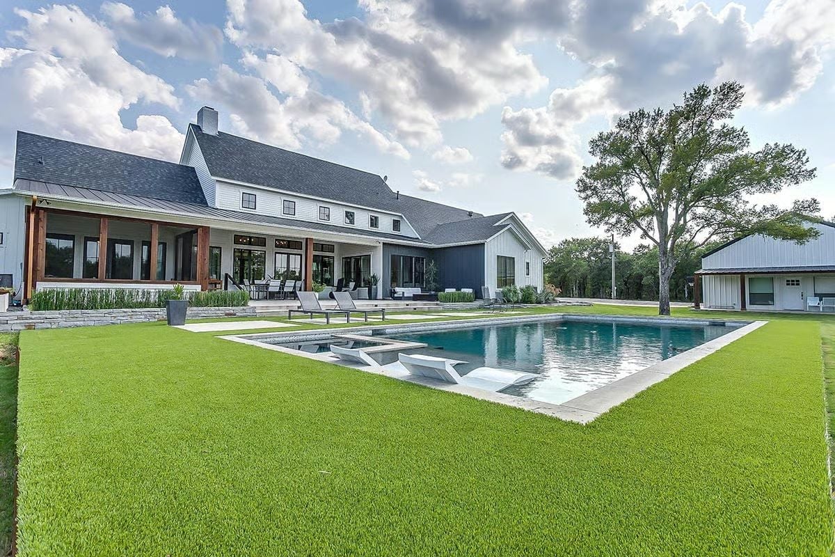Lush Backyard Where the Pool Deck and Covered Porch Pull Equal Weight