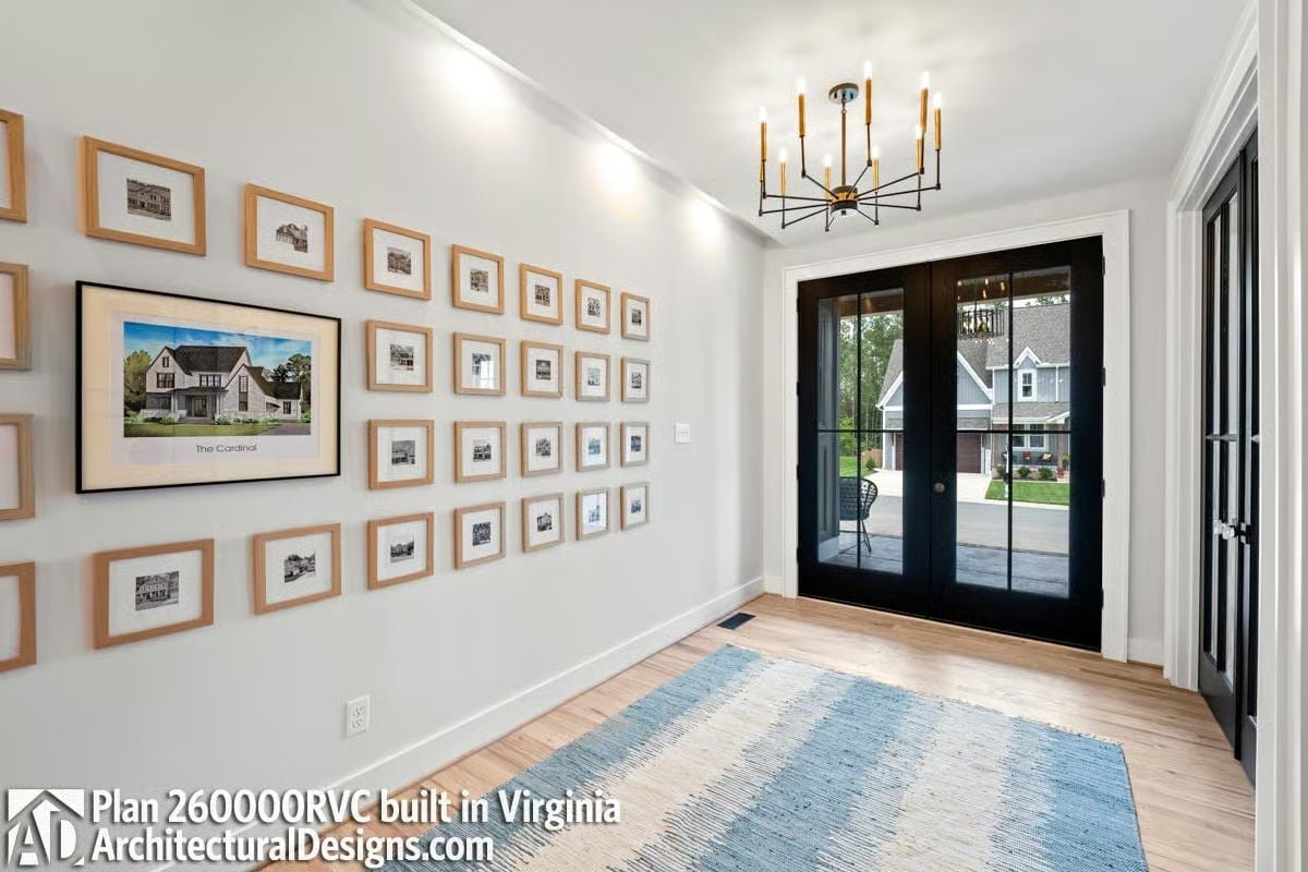 Gallery Wall Does Double Duty as a Builder's Portfolio in This Foyer