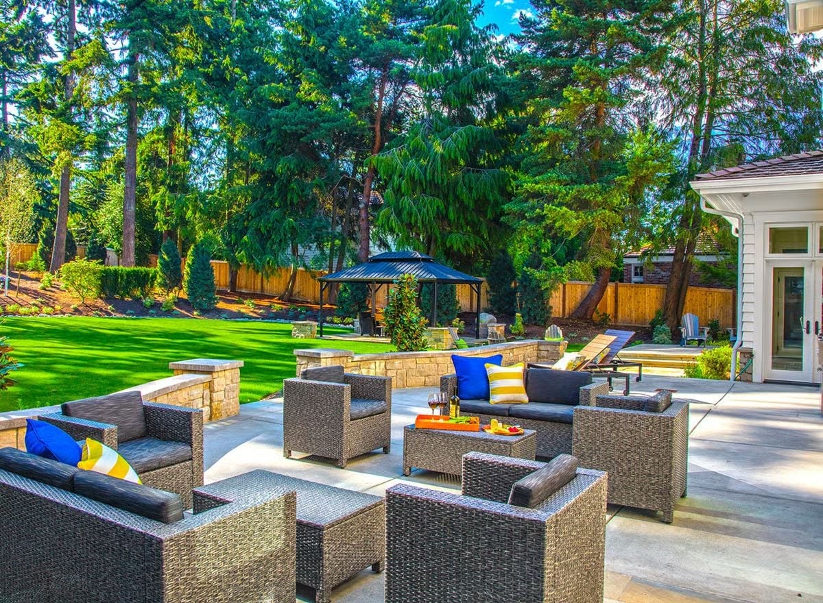 Wicker Seating, a Gazebo, and Tall Conifers That Do the Privacy Work For You