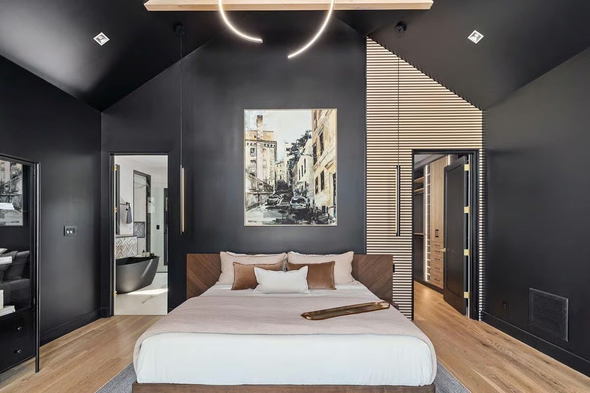 Dark Walls, a Wood-Slat Column, and a Bedroom That Pulls Off Drama Without Trying Too Hard