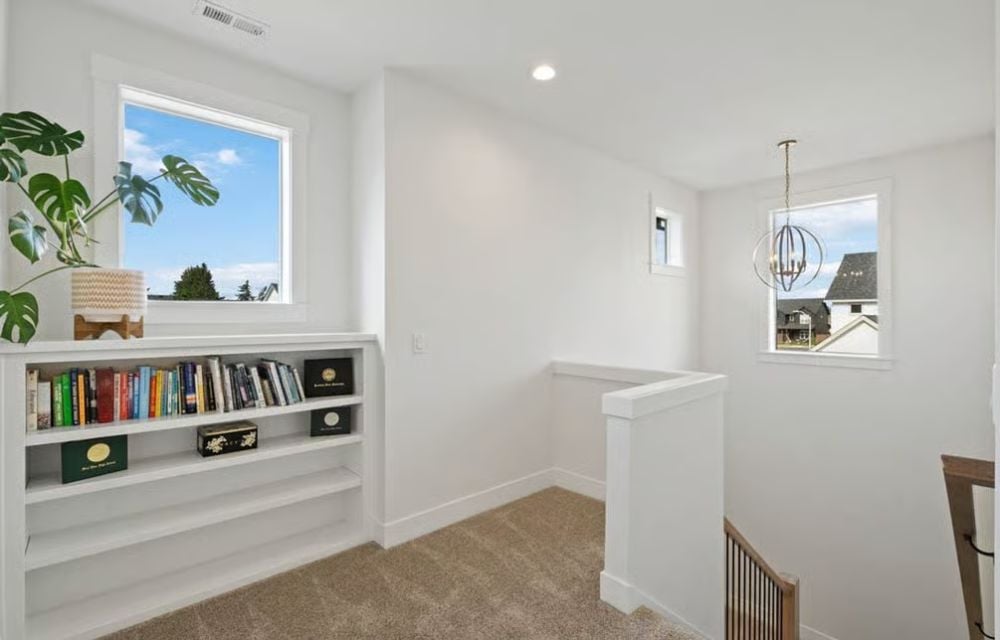 Built-In Shelves at the Top of the Stairs Solve the Problem of Where Books Actually Live