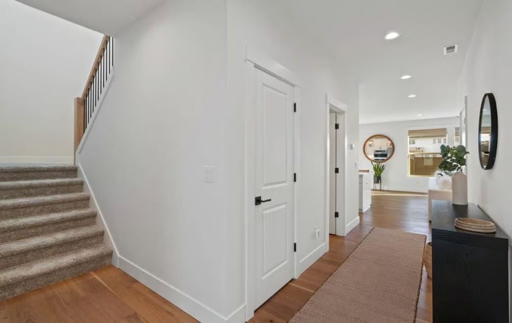 Staircase Hall Where the Hardwood Ends and the Carpet Begins