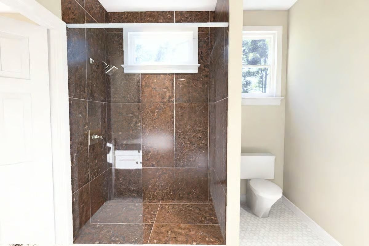 Dark Granite Tile and a Frameless Shower That Lets the Stone Do the Talking