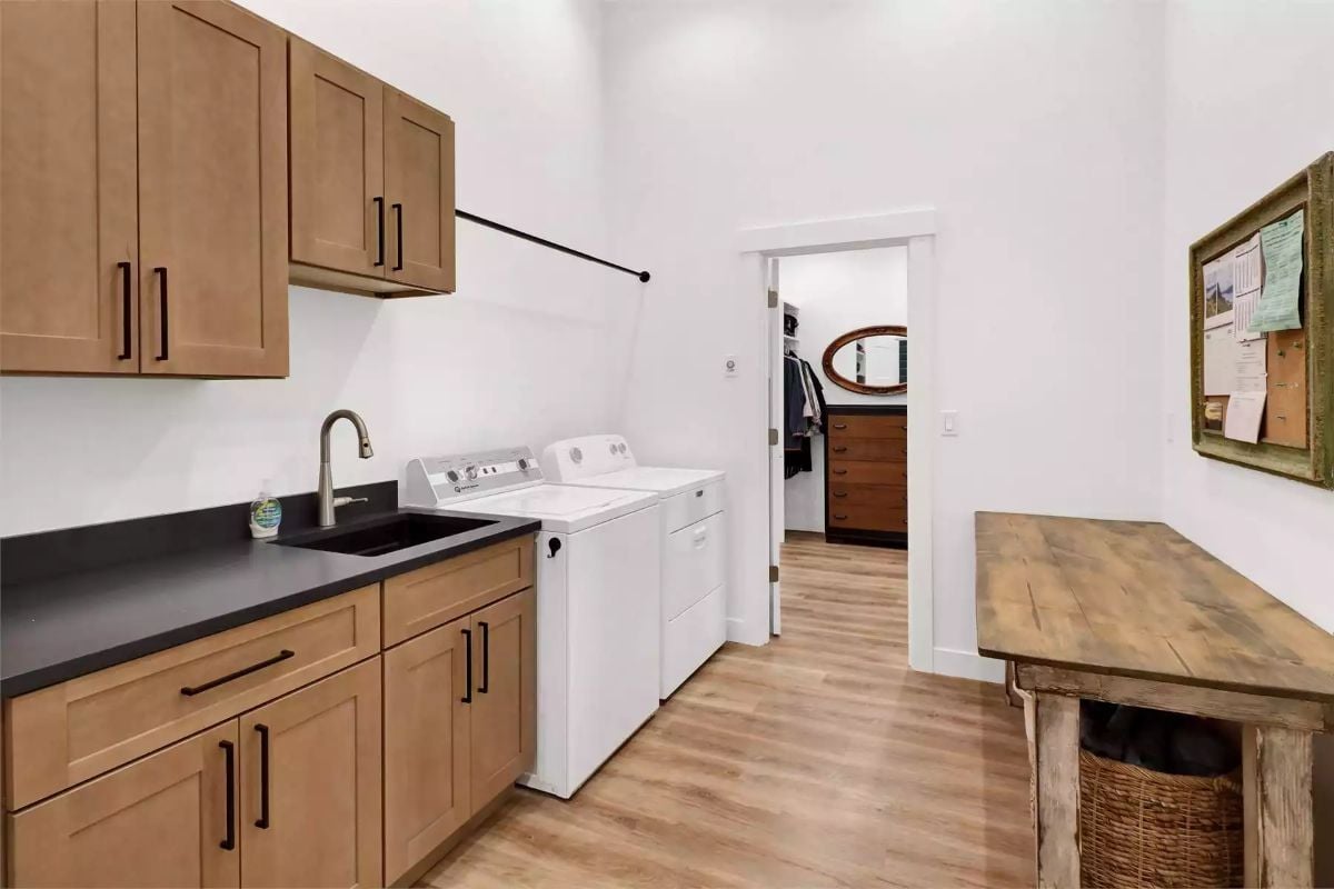 Hanging Rod, Black Sink, and Cabinetry That Pulls Its Weight