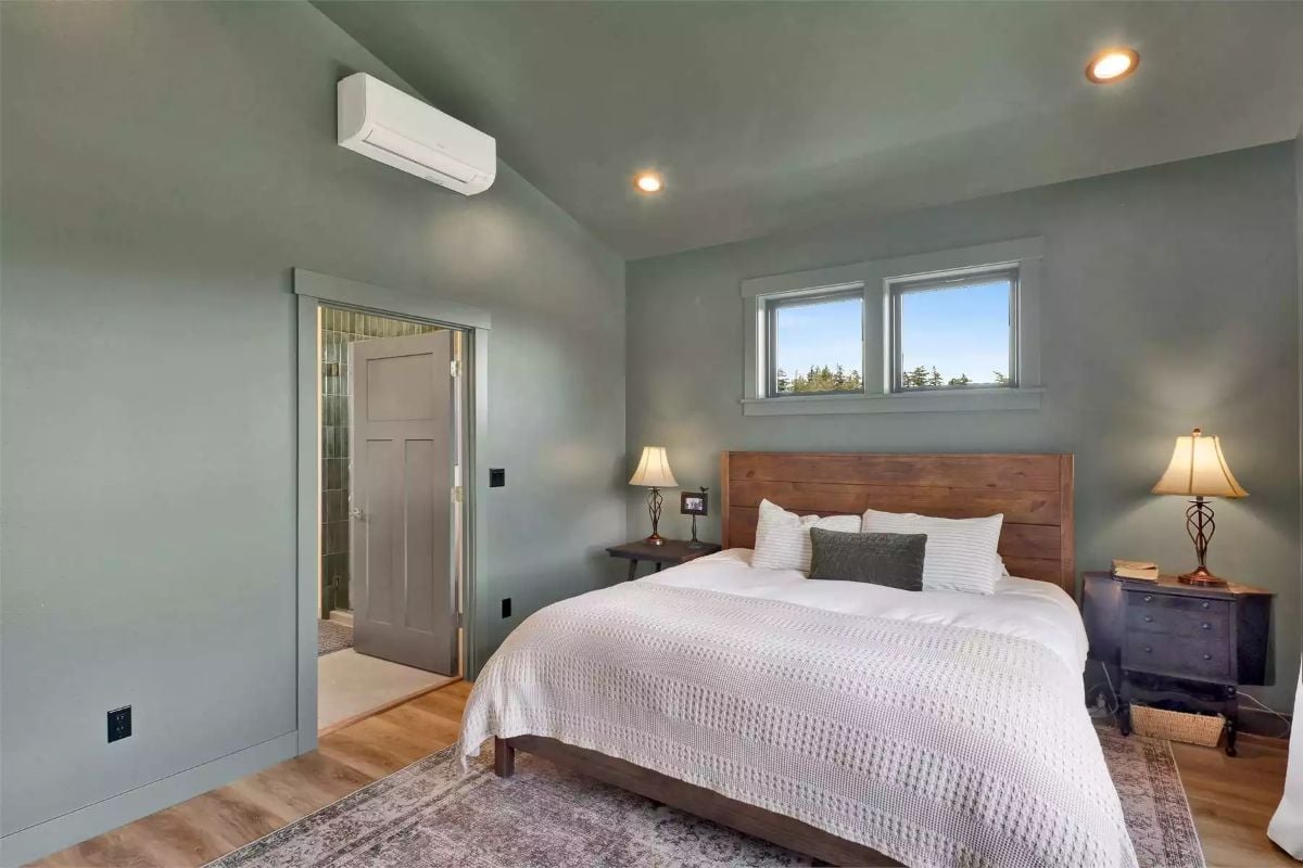 Mini-Split Above the Door, Wood Headboard, and a Bed That Doesn't Apologize