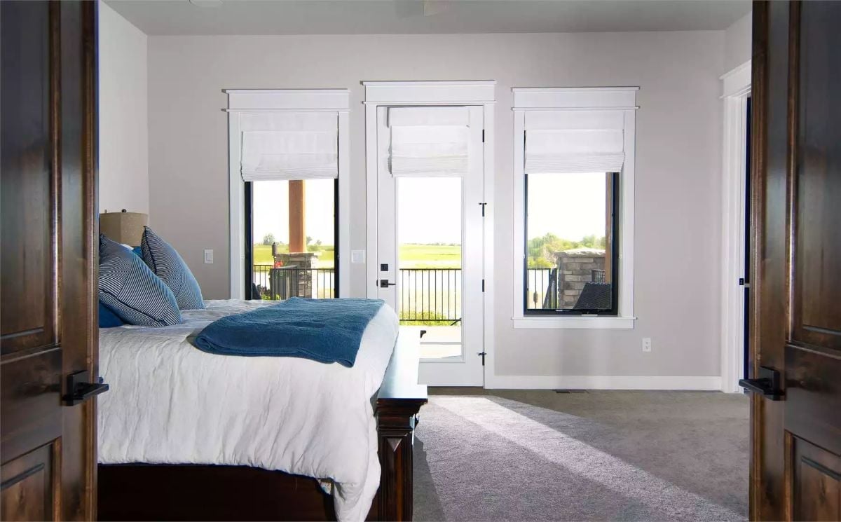 Roman Shades, Black Frames, and a Balcony Door That Invites the Outside In